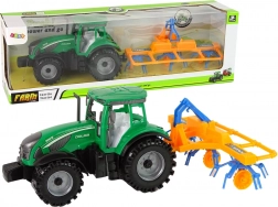 Groene tractor met hooihark en frictie-aandrijving
