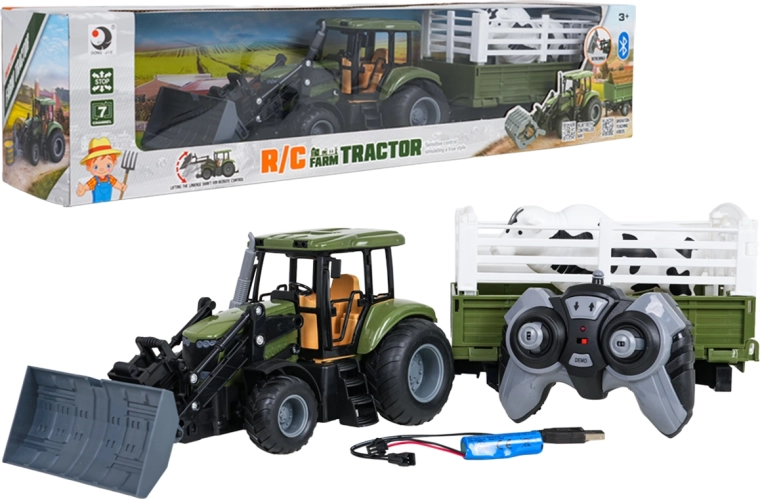 Groene op afstand bestuurbare tractor met aanhanger en stier 1:20