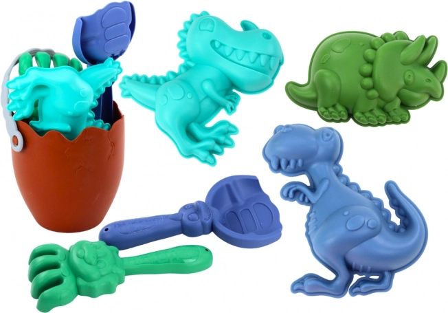 Zandset dinosaurussen met emmer in eivorm, schep, hark en vormpjes