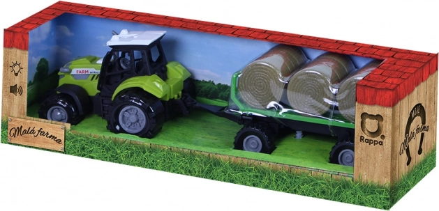 Tractor met geluid en licht met aanhanger en strobalen