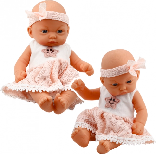 Babypop in roze jurk met haarband
