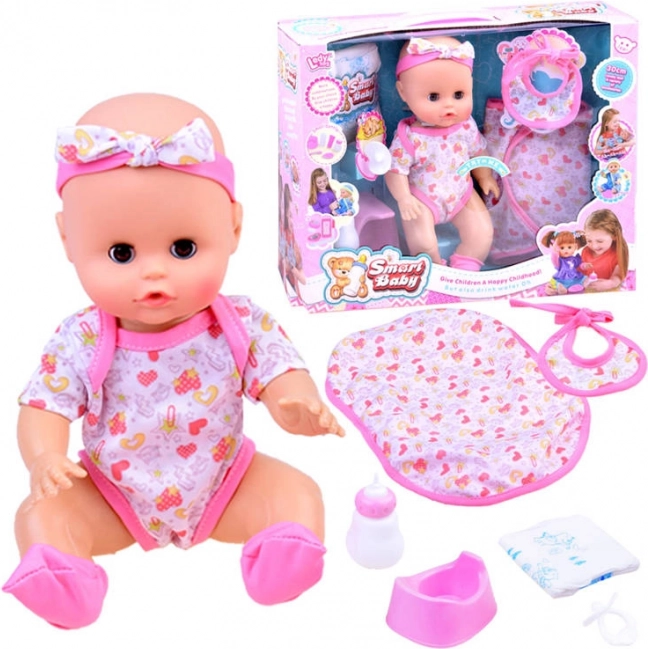 Interactieve babypop drinkt en plast met geluiden – Roze