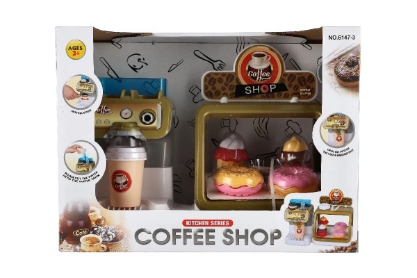 Speelgoedkinderkoffiehuis met koffiezetapparaat en gebakjes