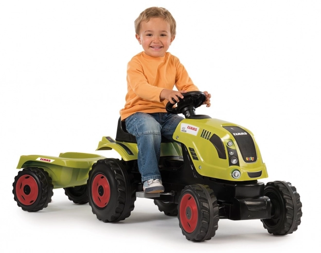 Tractor op trappers CLAAS Arion 400 met aanhangwagen groen