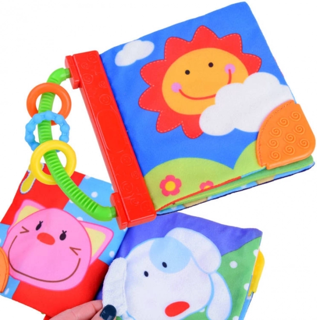 Zachte knisperende stoffen babyboek met bijtringen en ringen