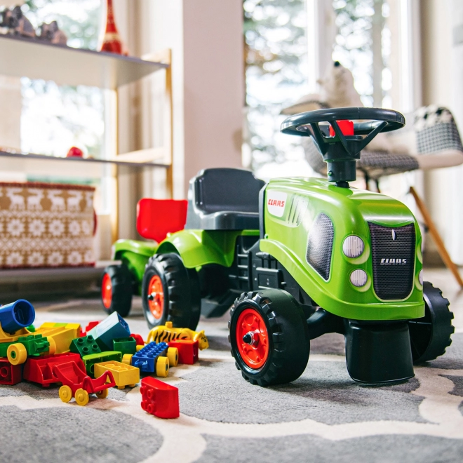 Duwtractor Claas groen met stuur en aanhanger