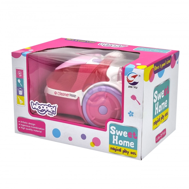 Roze kinderstofzuiger met zuigfunctie