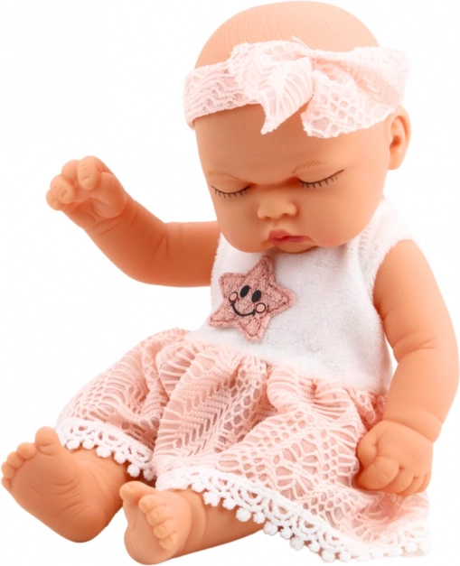 Pop slapende baby in roze jurk met kant en sterren hoofdband