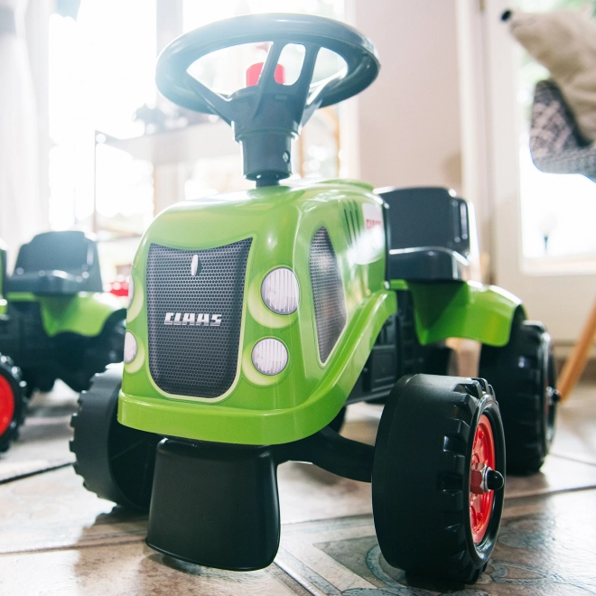 Duwtractor Claas groen met stuur en aanhanger