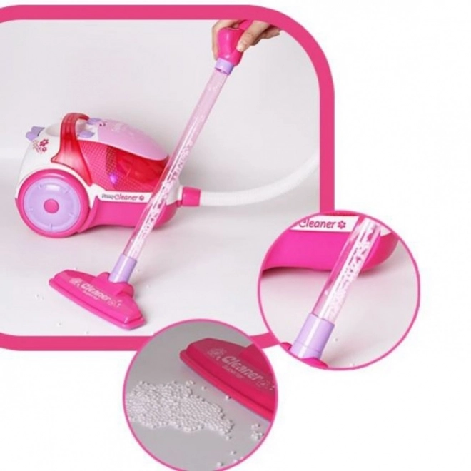 Roze kinderstofzuiger met zuigfunctie