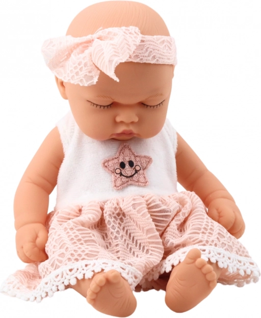 Pop slapende baby in roze jurk met kant en sterren hoofdband