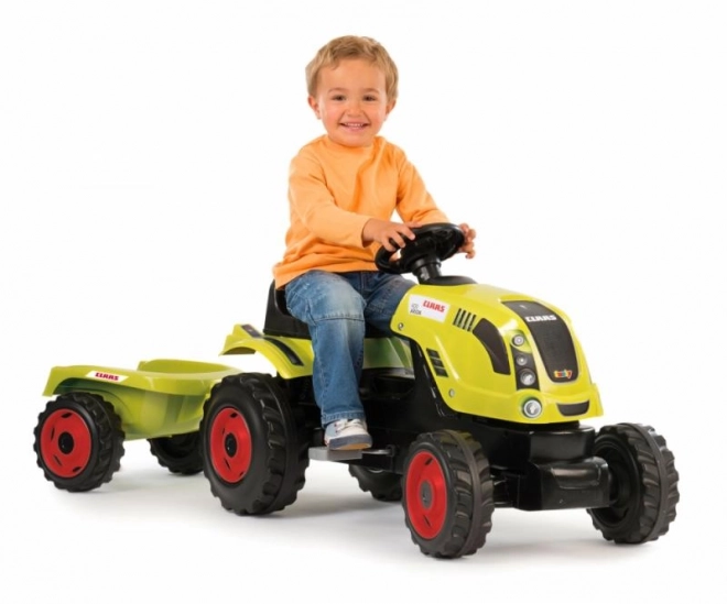 Tractor op trappers CLAAS Arion 400 met aanhangwagen groen