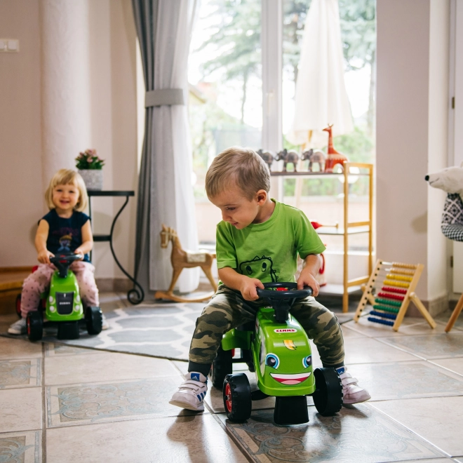 Duwtractor Claas groen met stuur en aanhanger