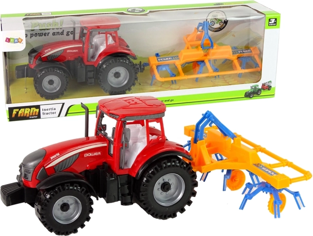 Rode tractor met harkaanhangwagen met wrijvingsaandrijving
