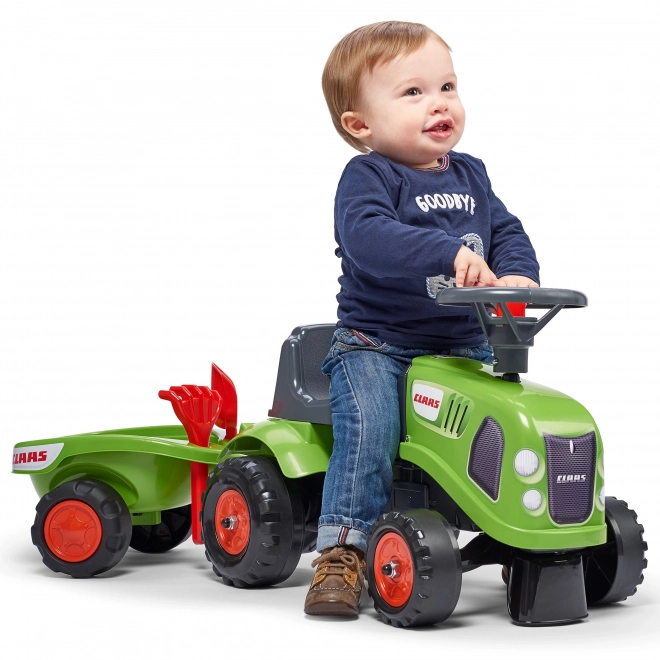 Duwtractor Claas groen met stuur en aanhanger