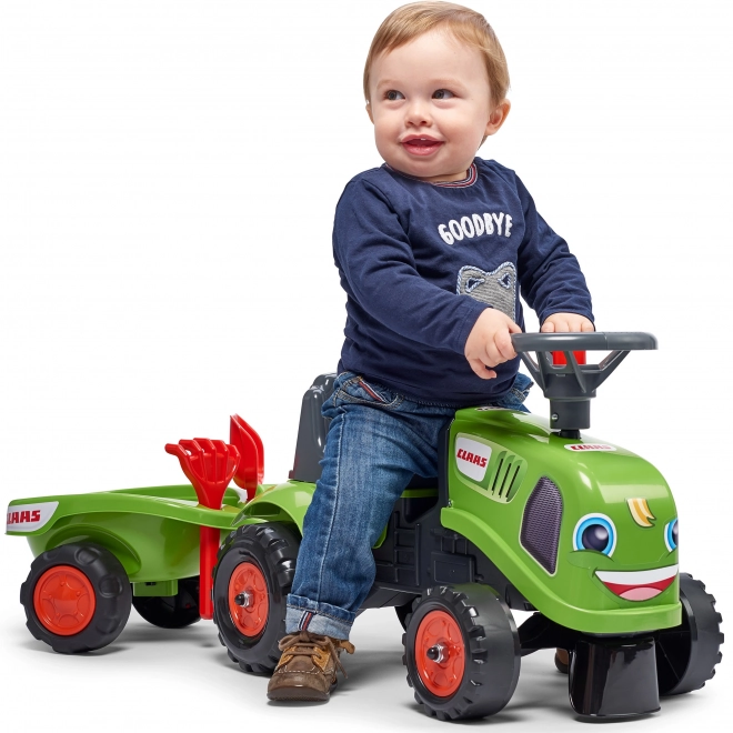 Duwtractor Claas groen met stuur en aanhanger
