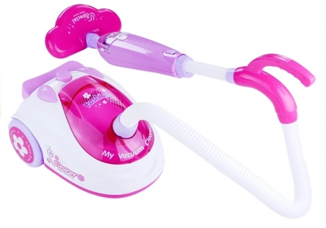 Roze kinderstofzuiger op batterijen met twee opzetstukken