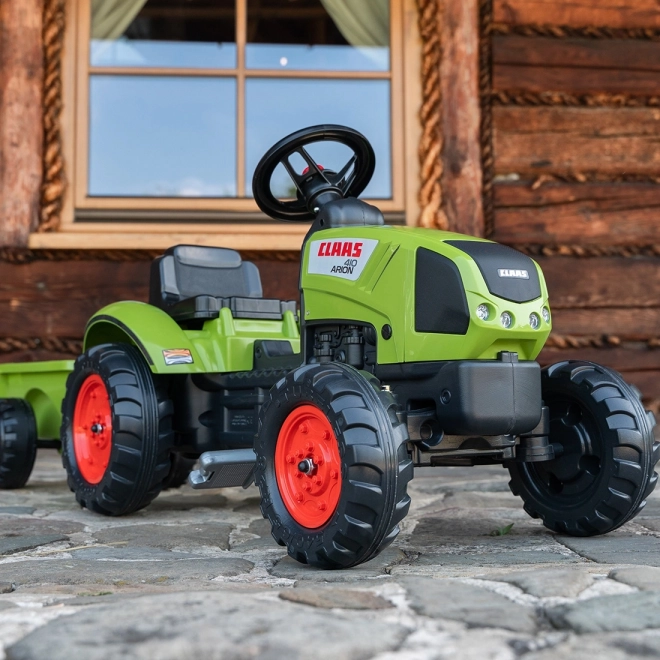 Trappertractor Claas Arion 410 met groene aanhanger