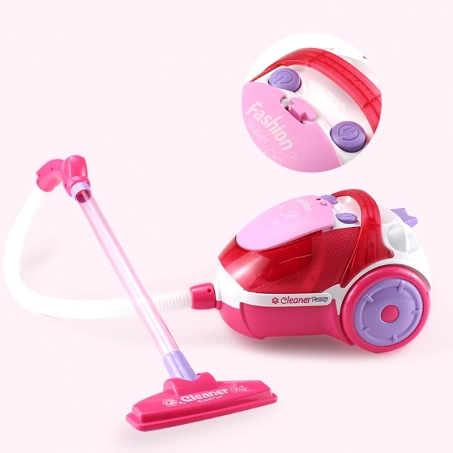 Roze kinderstofzuiger met zuigfunctie