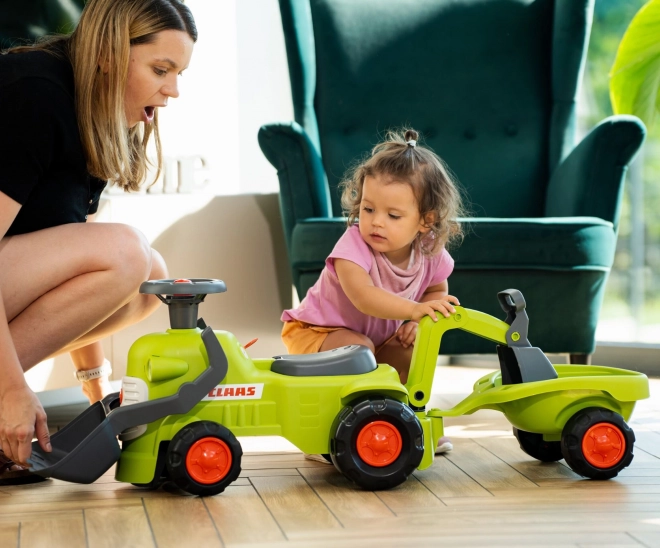 Rijdende tractor Claas met aanhanger, lader en schep