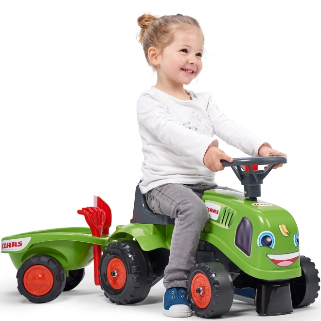 Duwtractor Claas groen met stuur en aanhanger