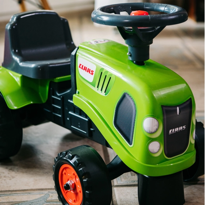 Duwtractor Claas groen met stuur en aanhanger