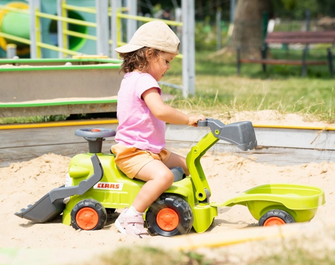 Rijdende tractor Claas met aanhanger, lader en schep