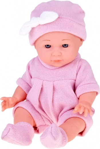 Realistische babypop in roze gebreide outfit