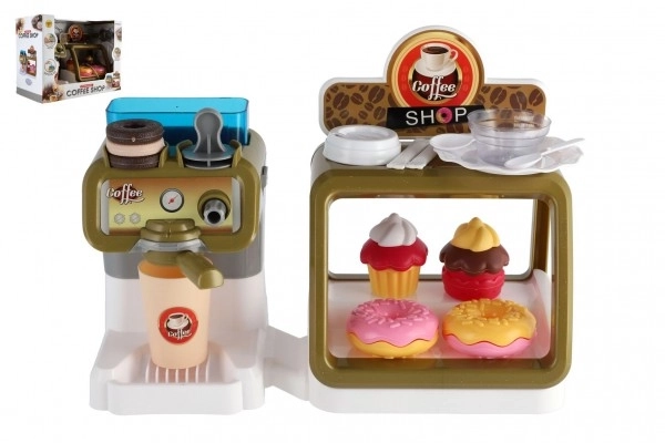 Speelgoedkinderkoffiehuis met koffiezetapparaat en gebakjes