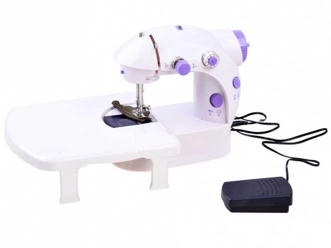 Mini naaimachine met voetpedaal en tafel