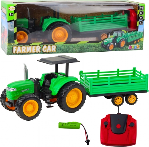 Groene op afstand bestuurbare boerderijtractor met aanhanger