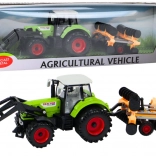 Tractor met schijveneg en frontlader groen